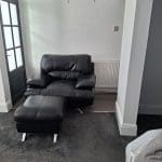 Black sofa and armchair with foot rest