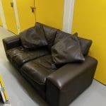 Two brown leather sofas
