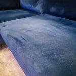Blue velvet chaise corner sofa with ottoman
