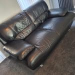 Black sofa and armchair with foot rest
