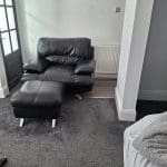 Black sofa and armchair with foot rest
