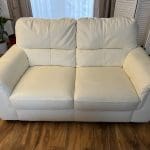 Two cream leather sofas.