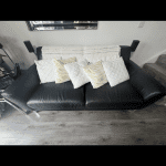 2 black leather sofas with silver feet from DFS