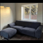 DFS black hardy 2 seater sofa and footstool