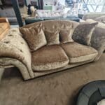 Beige/brown chesterfield sofas.